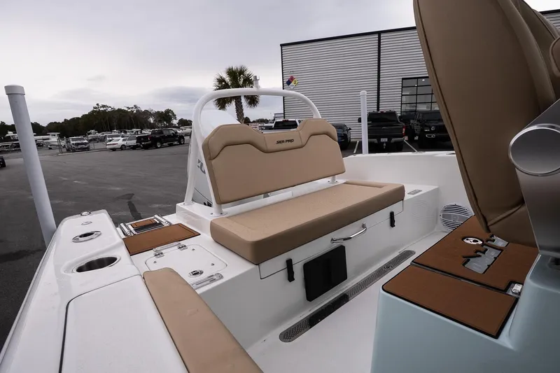 Slide: The Image of 2026 Sea Pro 245FLXR Sandbar boat interior with tan seating and storage compartments. - 10