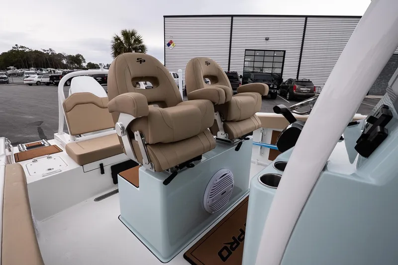 Slide: The Image of 2026 Sea Pro 245FLXR Sandbar boat interior with tan seating and modern controls. - 13
