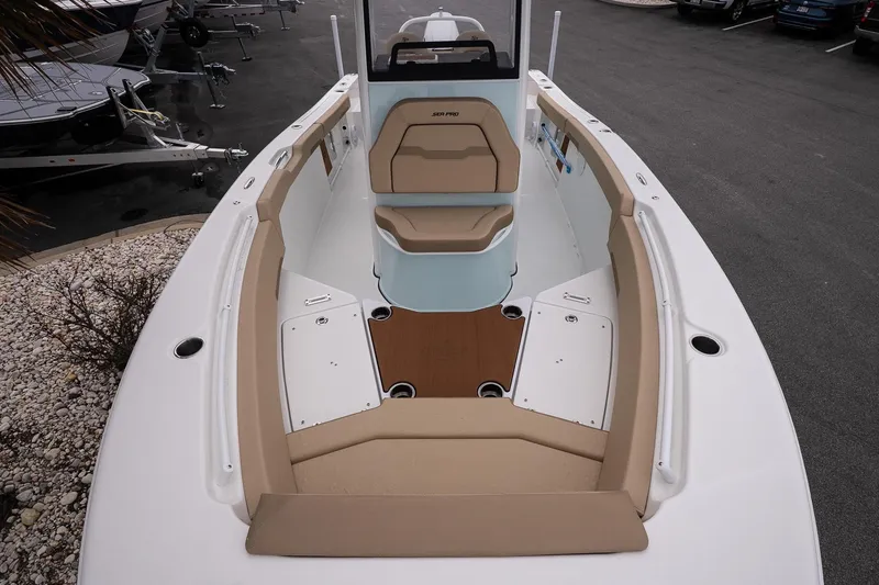 Slide: The Image of 2026 Sea Pro 245FLXR Sandbar boat interior with tan seating and white deck. - 16