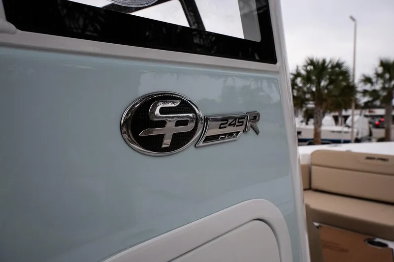 Slide: The Image of 2026 Sea Pro 245FLXR Sandbar boat emblem with palm trees in the background. - 18