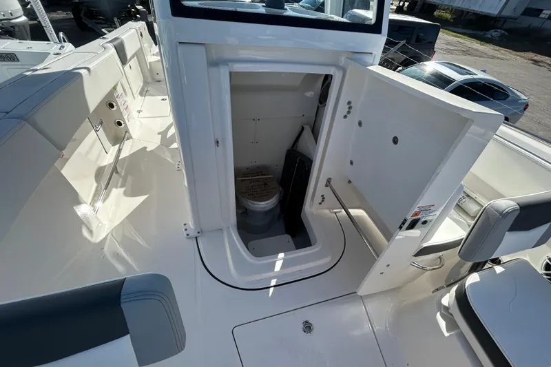 Slide: The Image of 2026 Robalo R250 Center Console boat interior with open storage compartment and seating. - 19