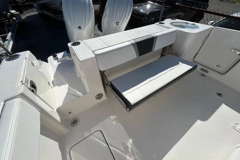 Slide: The Image of 2026 Robalo R250 Center Console boat interior with foldable seating and storage compartments. - 20