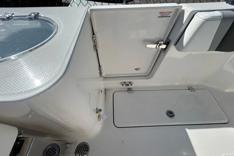 Slide: The Image of 2026 Robalo R250 Center Console boat interior with storage compartments and seating. - 22