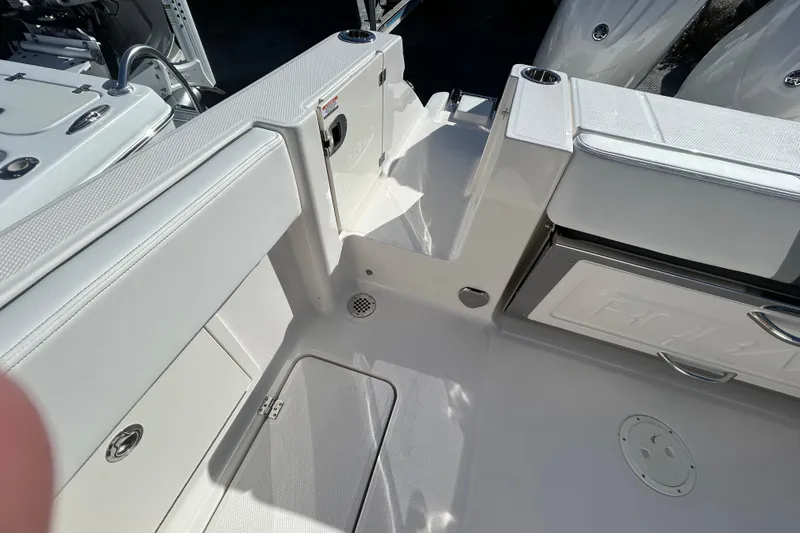 Slide: The Image of 2026 Robalo R250 Center Console boat interior with sleek white seating and storage compartments. - 24