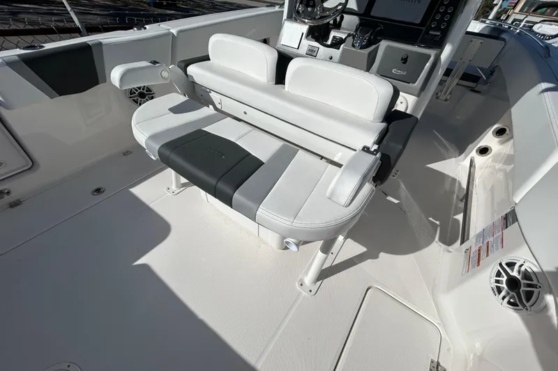 Slide: The Image of 2026 Robalo R250 Center Console boat interior with seating and control panel. - 6