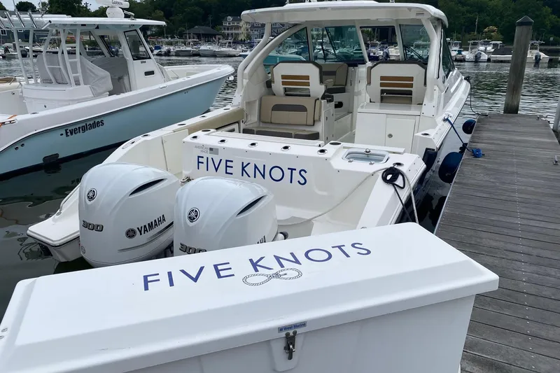 Slide: The Image of 2021 Pursuit DC 326 Dual Console boat docked with Yamaha engines, labeled "Five Knots." - 4