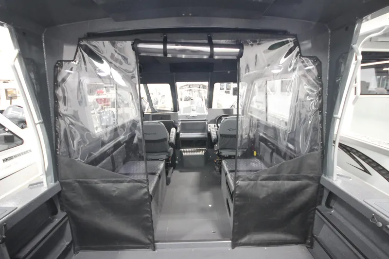 Slide: The Image of Interior of 2026 Weldcraft 240 Ocean King F300XCB boat, featuring spacious seating and clear dividers. - 19