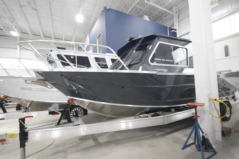 Slide: The Image of 2026 Weldcraft 240 Ocean King F300XCB boat in showroom, side view. - 2