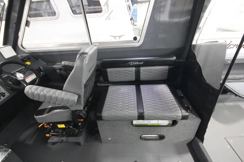 Slide: The Image of 2026 Weldcraft 240 Ocean King F300XCB interior with modern seating and steering console. - 25