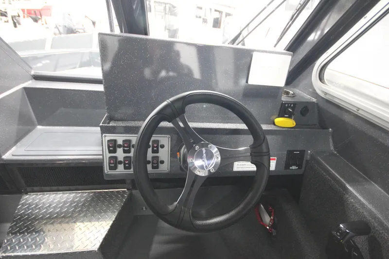 Slide: The Image of 2026 Weldcraft 240 Ocean King F300XCB boat helm with steering wheel and control panel. - 30