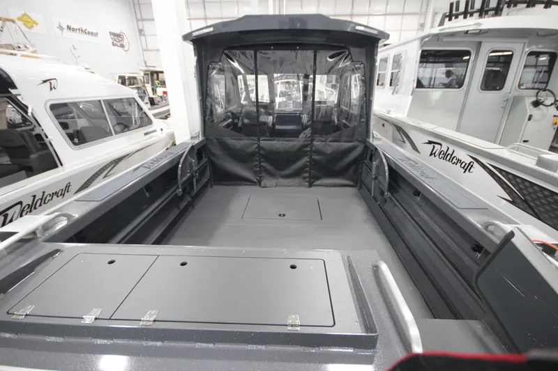 Slide: The Image of 2026 Weldcraft 240 Ocean King F300XCB boat interior, showcasing spacious deck and seating area. - 11
