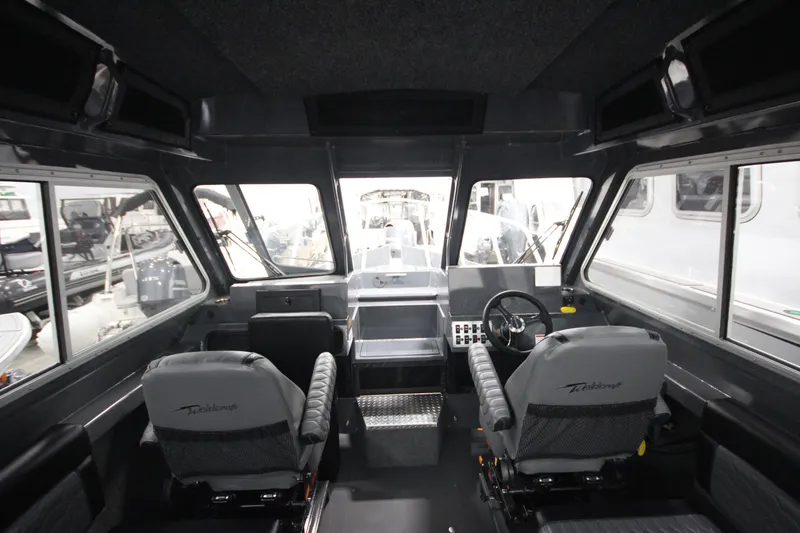 Slide: The Image of Interior of 2026 Weldcraft 240 Ocean King F300XCB boat, featuring modern helm and seating. - 21