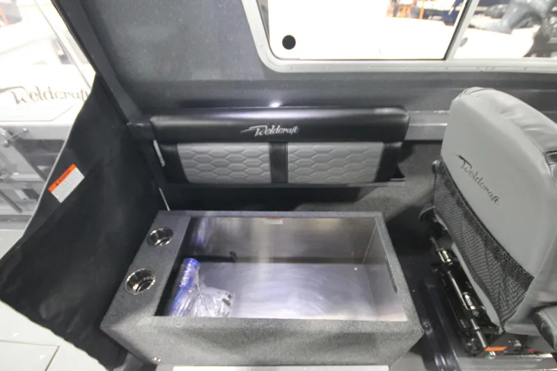 Slide: The Image of Interior of 2026 Weldcraft 240 Ocean King F300XCB boat, featuring seating and storage. - 24