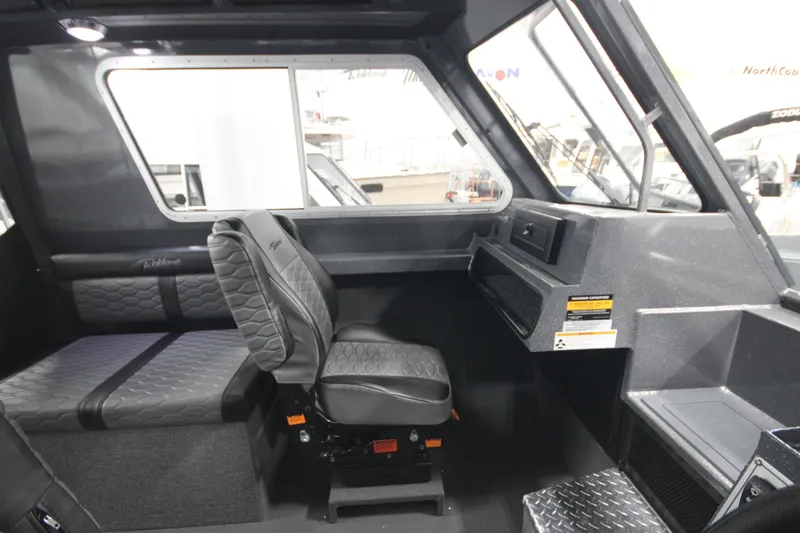 Slide: The Image of Interior of 2026 Weldcraft 240 Ocean King F300XCB boat, featuring seating and dashboard. - 27
