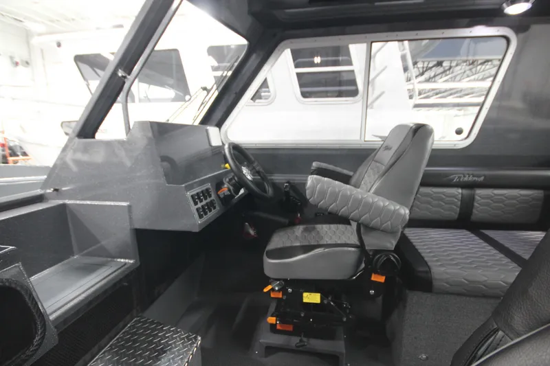 Slide: The Image of 2026 Weldcraft 240 Ocean King F300XCB boat interior with modern seating and controls. - 29