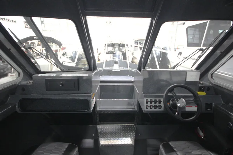 Slide: The Image of Interior view of 2026 Weldcraft 240 Ocean King boat cockpit with steering wheel. - 32
