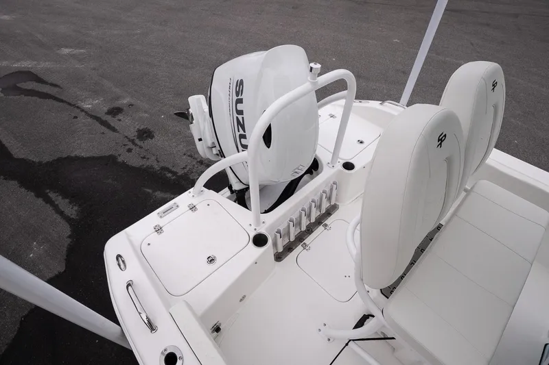 Slide: The Image of 2026 Sea Pro 202 Center Console boat with Suzuki outboard motor, white seating, and rod holders. - 10