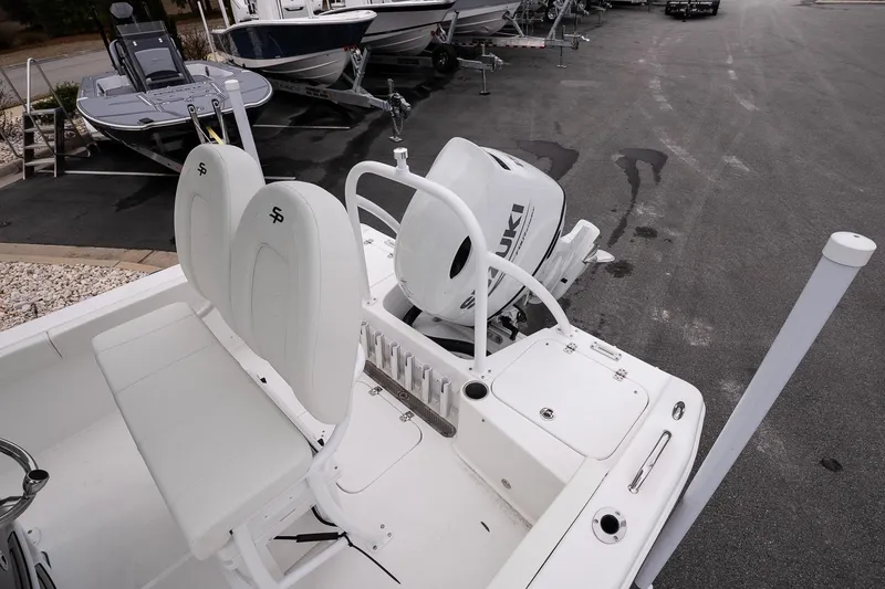 Slide: The Image of 2026 Sea Pro 202 Center Console boat with Suzuki outboard engine, parked on asphalt. - 11