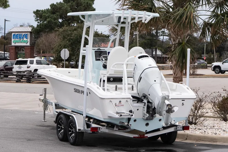 Slide: The Image of 2026 Sea Pro 202 Center Console boat on trailer near sport shop. - 4