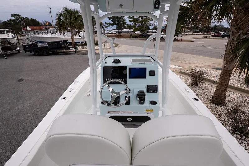 Slide: The Image of 2026 Sea Pro 202 Center Console boat interior with steering wheel and control panel. - 7