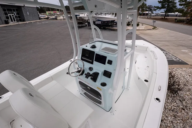 Slide: The Image of 2026 Sea Pro 202 Center Console boat interior with steering wheel and seating. - 9