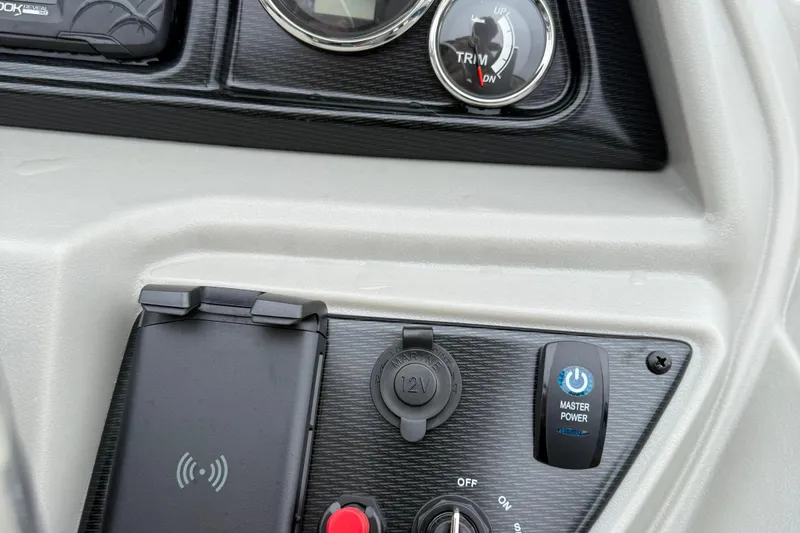 Slide: The Image of Control panel of 2026 Berkshire 22RFX LE boat with power and trim gauges. - 13