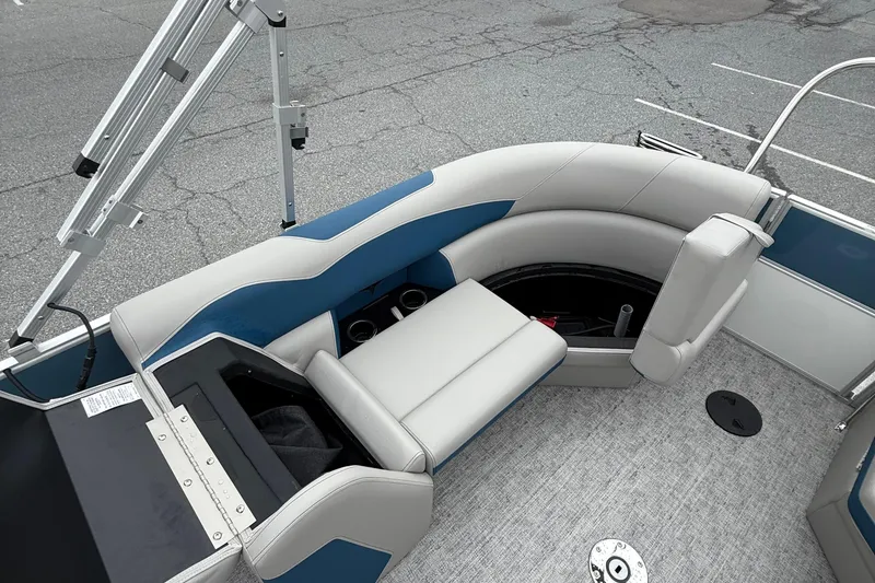 Slide: The Image of 2026 Berkshire 22RFX LE boat interior with gray and blue seating, storage compartments, and cup holders. - 14
