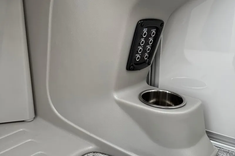 Slide: The Image of Control panel and cup holder in 2026 Berkshire 22RFX LE boat interior. - 16