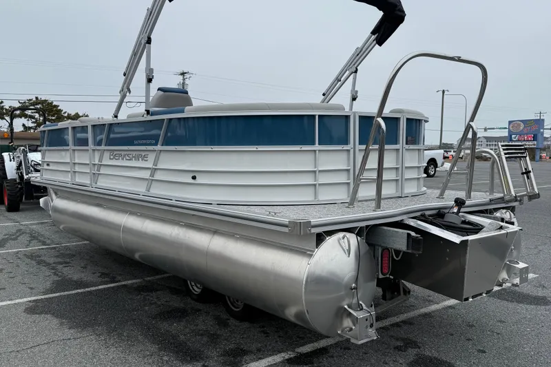 Slide: The Image of 2026 Berkshire 22RFX LE pontoon boat in a parking lot, side view. - 5