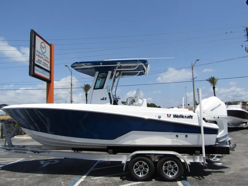 The Image of 2024 Wellcraft 243 Fisherman boat on a trailer in a parking lot. - 0