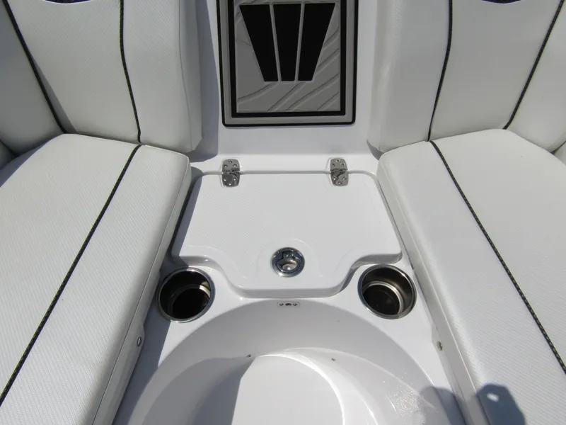Slide: The Image of 2024 Wellcraft 243 Fisherman boat seating area with cup holders and storage compartment. - 12