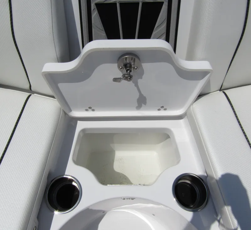 Slide: The Image of 2024 Wellcraft 243 Fisherman boat interior with open storage compartment and cup holders. - 13