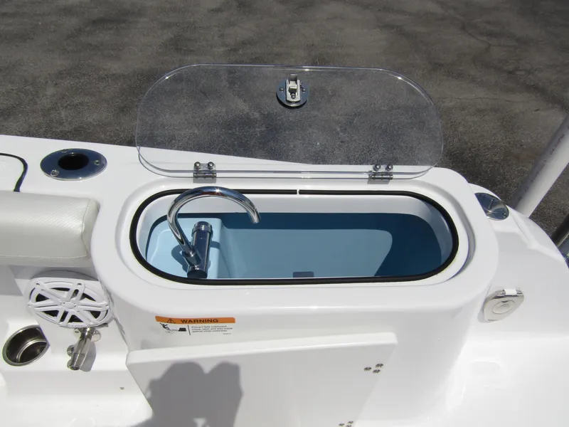Slide: The Image of 2024 Wellcraft 243 Fisherman boat livewell with open lid and faucet. - 33