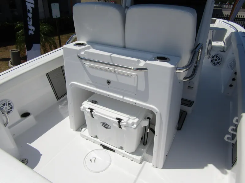 Slide: The Image of 2024 Wellcraft 243 Fisherman boat interior with cooler storage and seating. - 35