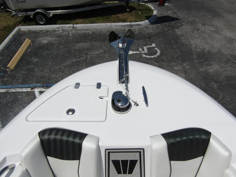 Slide: The Image of 2024 Wellcraft 243 Fisherman boat bow with anchor and seating. - 7