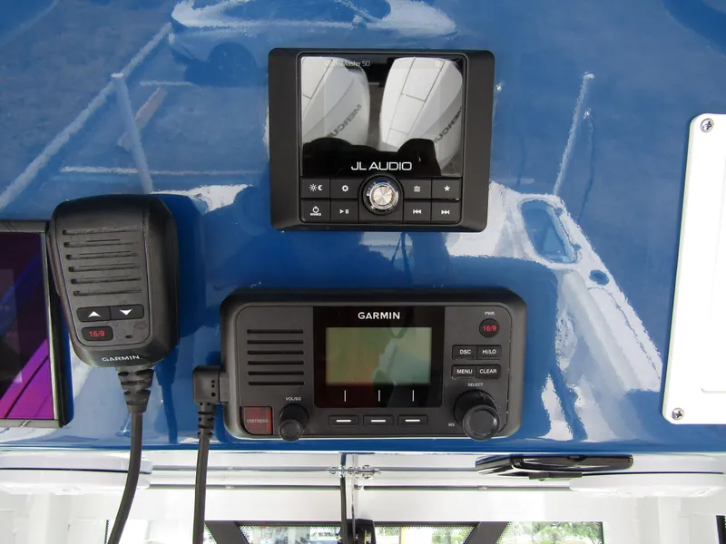 Slide: The Image of 2024 Wellcraft 243 Fisherman dashboard with Garmin and JL Audio equipment. - 23