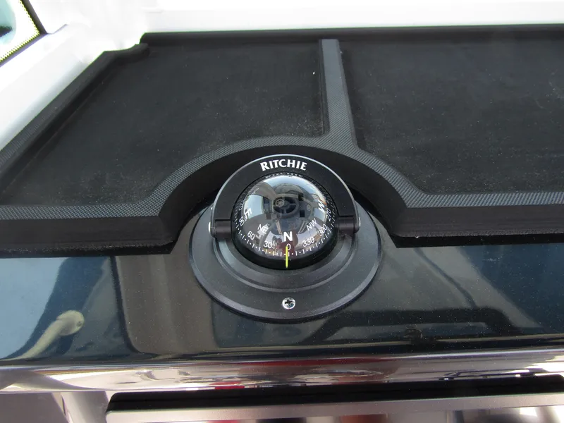 Slide: The Image of 2024 Wellcraft 243 Fisherman compass on dashboard. - 24