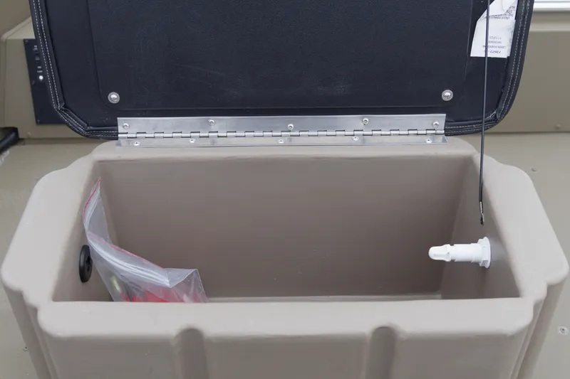 Slide: The Image of Open storage compartment in 2026 G3 Gator Tough 16 FL boat, featuring a drain plug. - 11