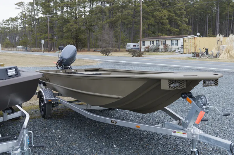 Slide: The Image of 2026 G3 Gator Tough 16 FL boat on trailer, parked outdoors near road. - 4