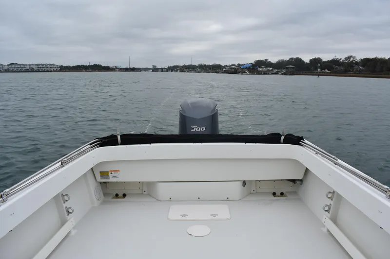 Slide: The Image of 2015 Parker 2320 SL Sport Cabin boat on calm water, overcast sky. - 13