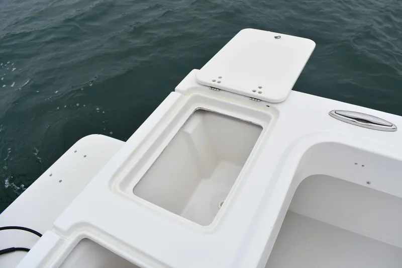 Slide: The Image of 2015 Parker 2320 SL Sport Cabin boat with open storage compartment on deck. - 14