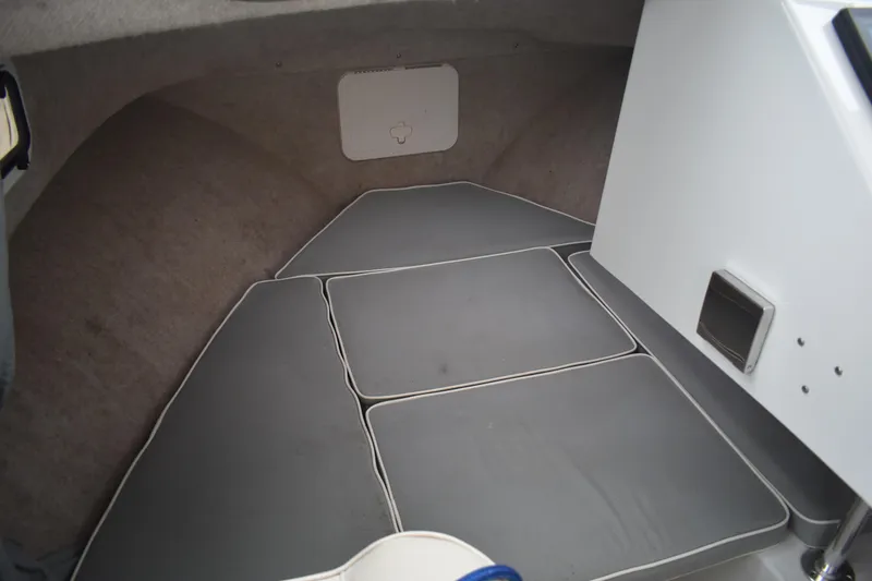 Slide: The Image of 2015 Parker 2320 SL Sport Cabin interior with cushioned seating and storage compartment. - 17