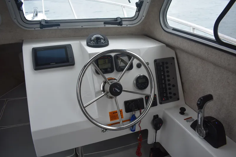 Slide: The Image of Steering console of 2015 Parker 2320 SL Sport Cabin boat with navigation equipment. - 8