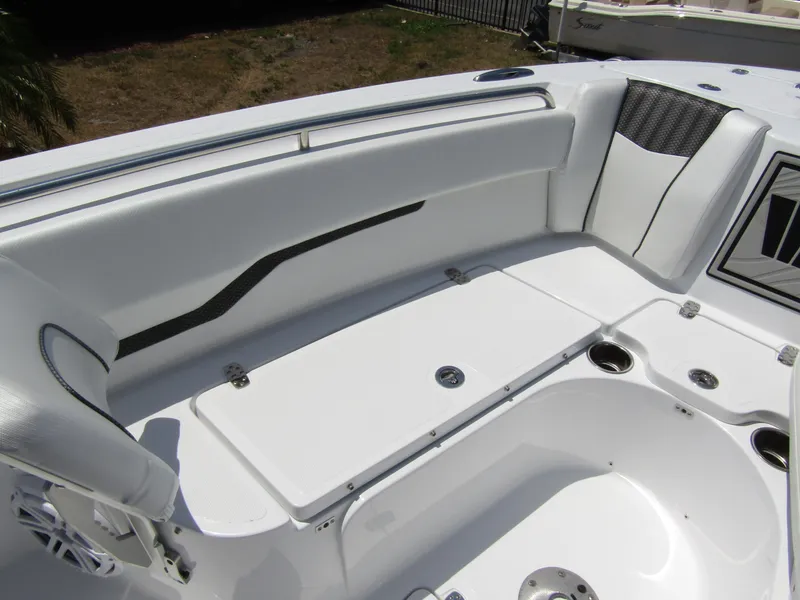 Slide: The Image of 2024 Wellcraft 243 Fisherman boat interior seating area with white upholstery. - 10