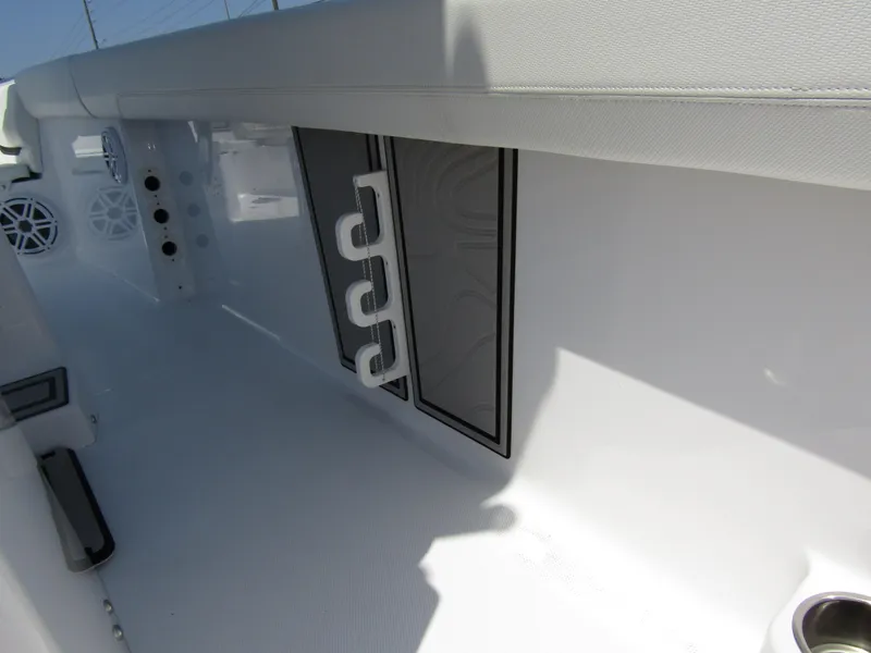 Slide: The Image of 2024 Wellcraft 243 Fisherman boat interior with rod holders and storage compartments. - 29