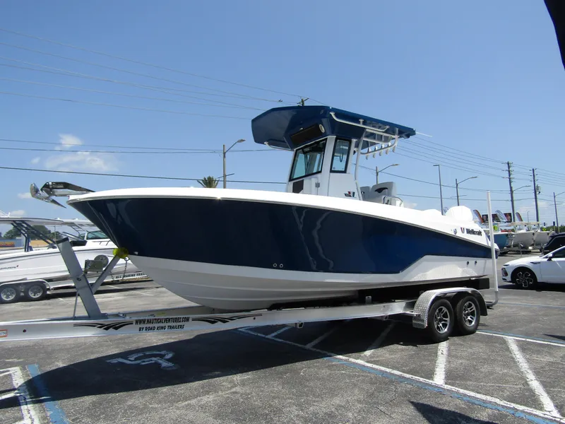 Slide: The Image of 2024 Wellcraft 243 Fisherman boat on a trailer in a parking lot. - 6