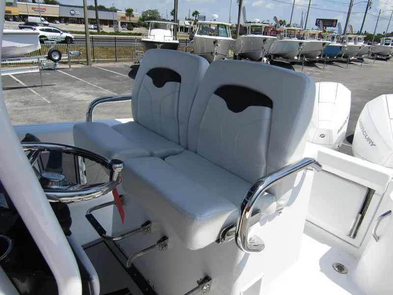 Slide: The Image of 2024 Wellcraft 243 Fisherman boat with dual captain's chairs and steering wheel. - 19