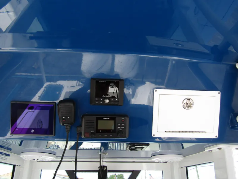 Slide: The Image of 2024 Wellcraft 243 Fisherman boat dashboard with navigation and communication equipment. - 21