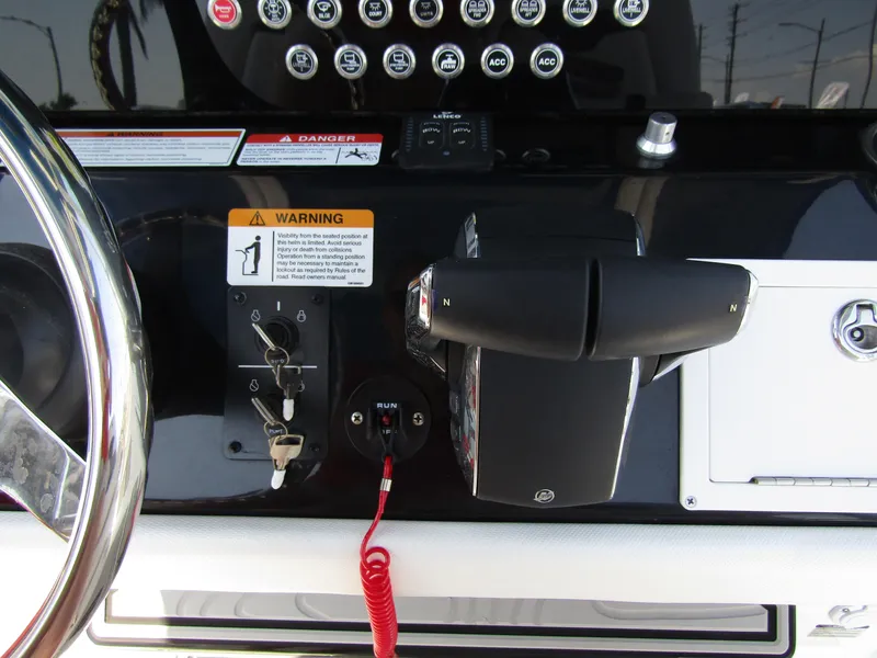 Slide: The Image of Control panel of 2024 Wellcraft 243 Fisherman boat with steering wheel and throttle. - 28