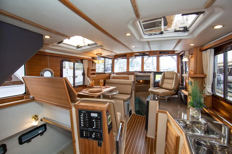 Slide: The Image of Manufacturer Provided Image: Luxurious interior of 2025 Ranger Tugs R-31 CB yacht with wood finishes and modern amenities. - 11